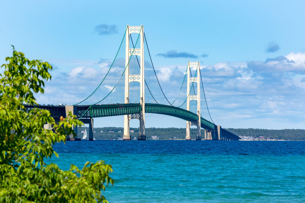 Pure Michigan Campaign Urges Safe Tourism A suspension bridge spanning the Straits of Mackinac to connect the Upper and Lower Peninsulas of Michigan