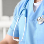 closeup of male nurse with stethoscope around neck