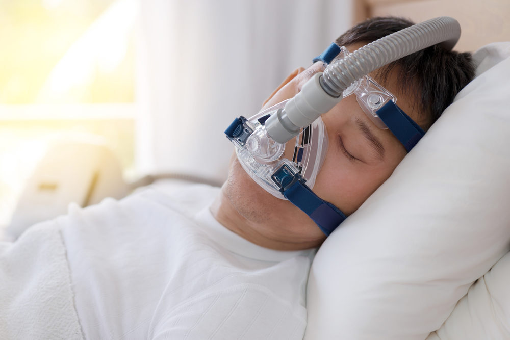 senior man wearing cpap mask sleeping