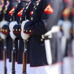 marine corps lineup of soldiers in dress uniform with rifles