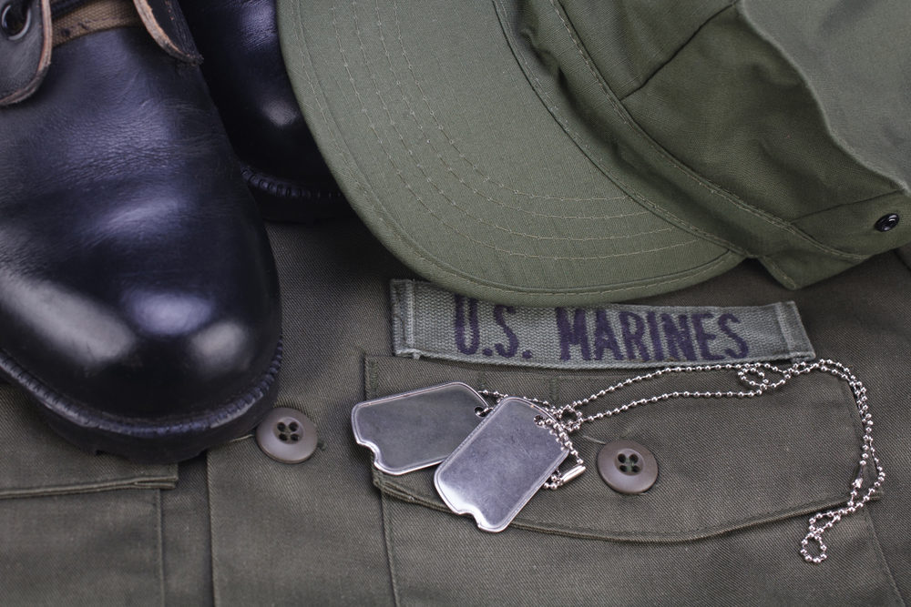 U.S. MARINES Branch Tape with dog tags and boots on olive green uniform background