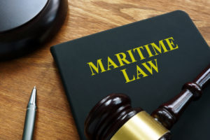 Maritime law black book and wooden gavel.