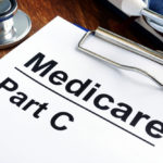 medicare part c forms on desk with a stethoscope