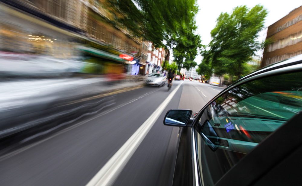 Mirror view of speeding car.