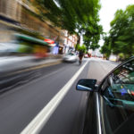 Mirror view of speeding car.