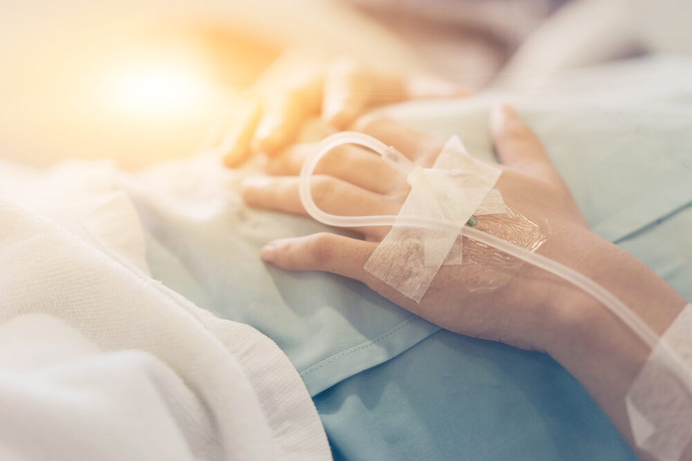 closeup of a mother's hands after giving birth connected to iv