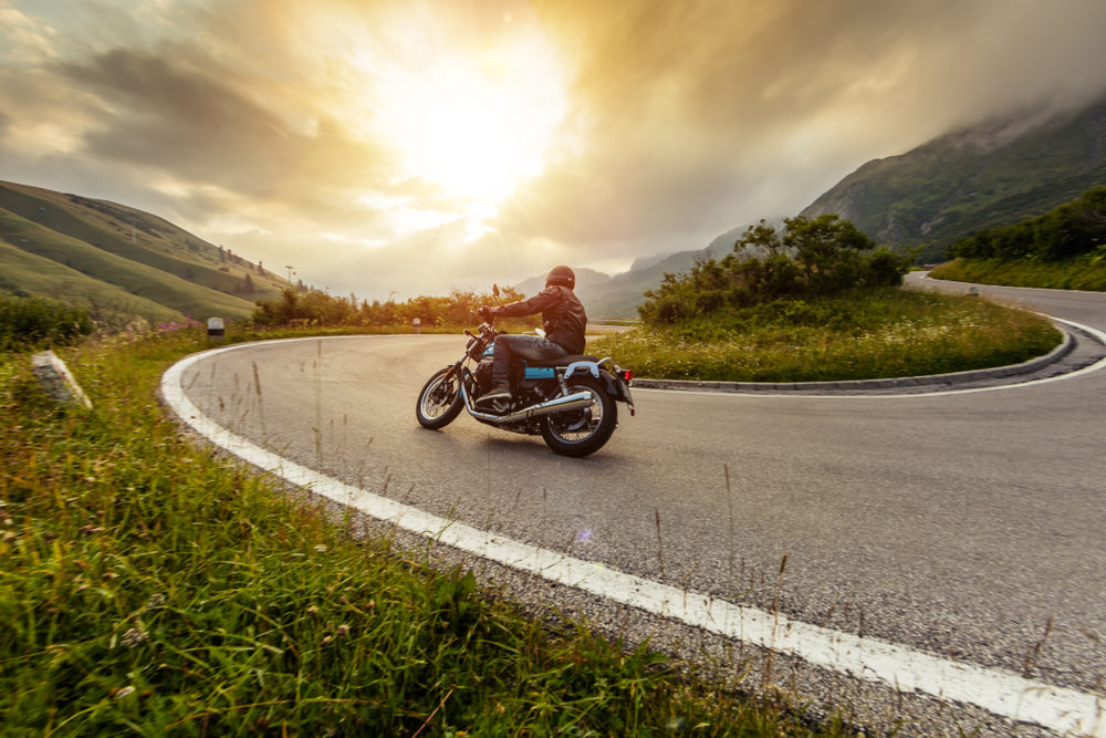Recoverable Damages After a Motorcyclist Passes Away in a Nebraska/Iowa Collision Motorcycle driver riding in Alpine landscape.