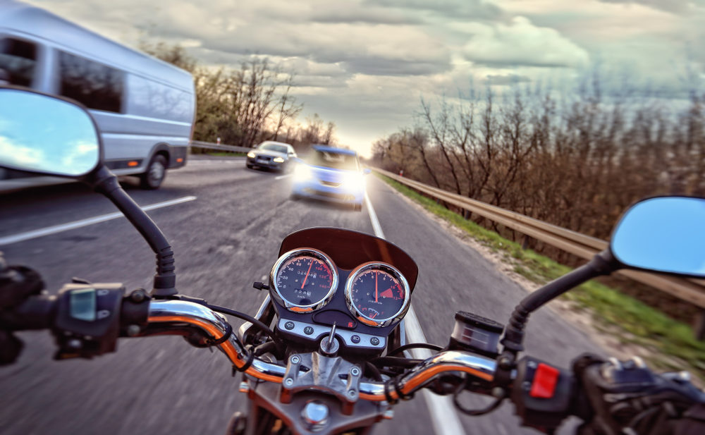 A motorcycle rider heading towards oncoming traffic