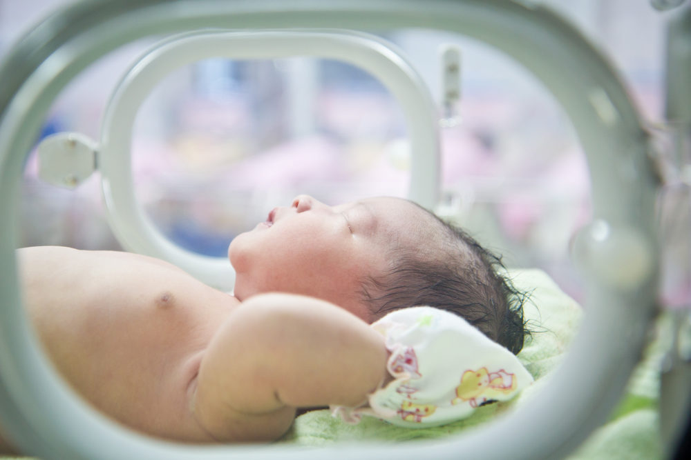 newborn baby in incubator care at nursery