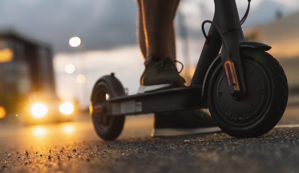 Lithium-Ion Battery Sparked Blaze in Manhattan High-Rise Building, Injuring 38 Young man at night with e-scooter in the city