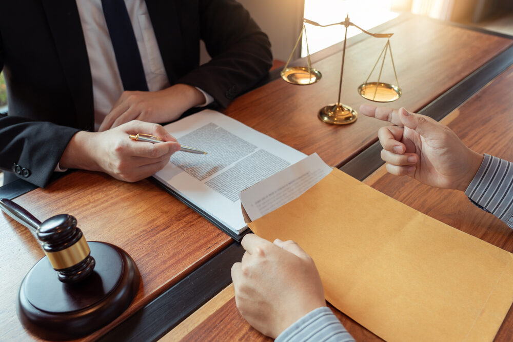 Male Notary lawyer discussing contract papers with Businessman in office