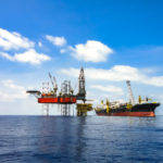 Offshore oil field area viewed with FPSO ship and drilling rig on platform