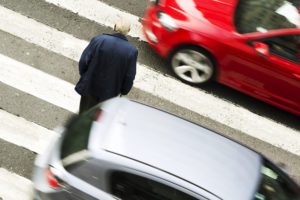 old man in dangerous situation in crosswalk with cars on both sides of him