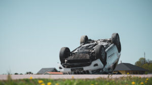 overturned white suv in roadway after an accident