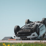 overturned white suv in roadway after an accident