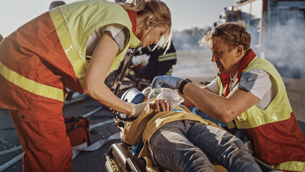 Paramedics Saving Life of a Traffic Accident Victim who is Lying on Stretcher