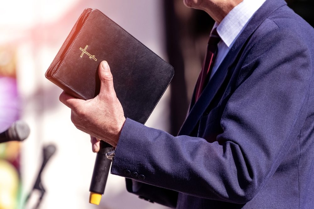 Pastor with a Bible in his hand during a sermon. 