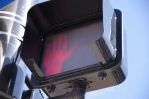 Pedestrian crossing traffic light-red light upraised hand signal indicator for do not walk