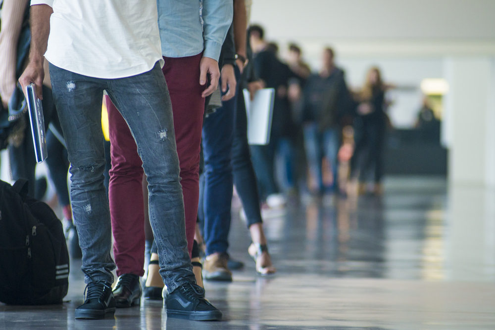 A long line-up of people indoors