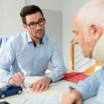 An injured man wearing a neck brace speaks to a lawyer