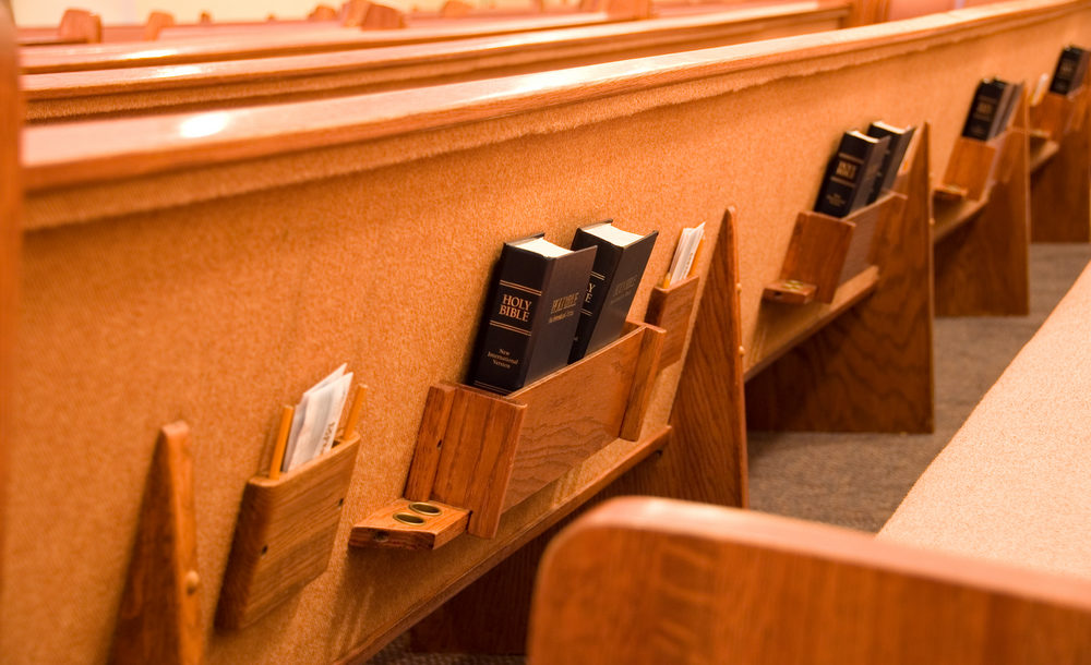 Holy Bible in the back of a pew in a sanctuary