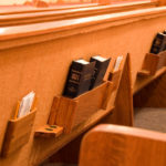 Holy Bible in the back of a pew in a sanctuary