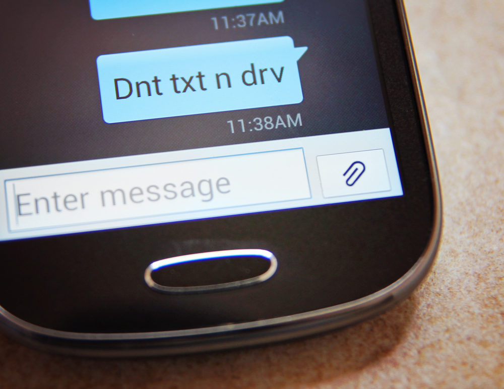 Attention Virginia Drivers: Remain Aware of the Risks of Distracted Driving Cell phone message Don't Text & Drive close up