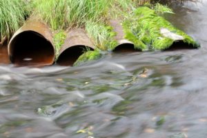 pipes into running water over rocks