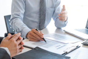 Insurance agent explaining insurance policy to customer.