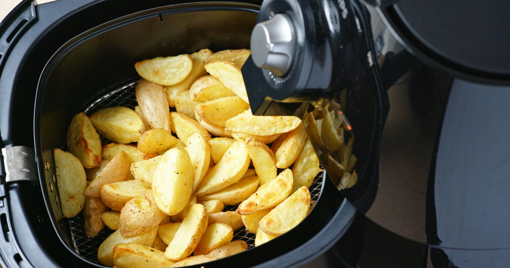 potatoes in a black air fryer closeup 