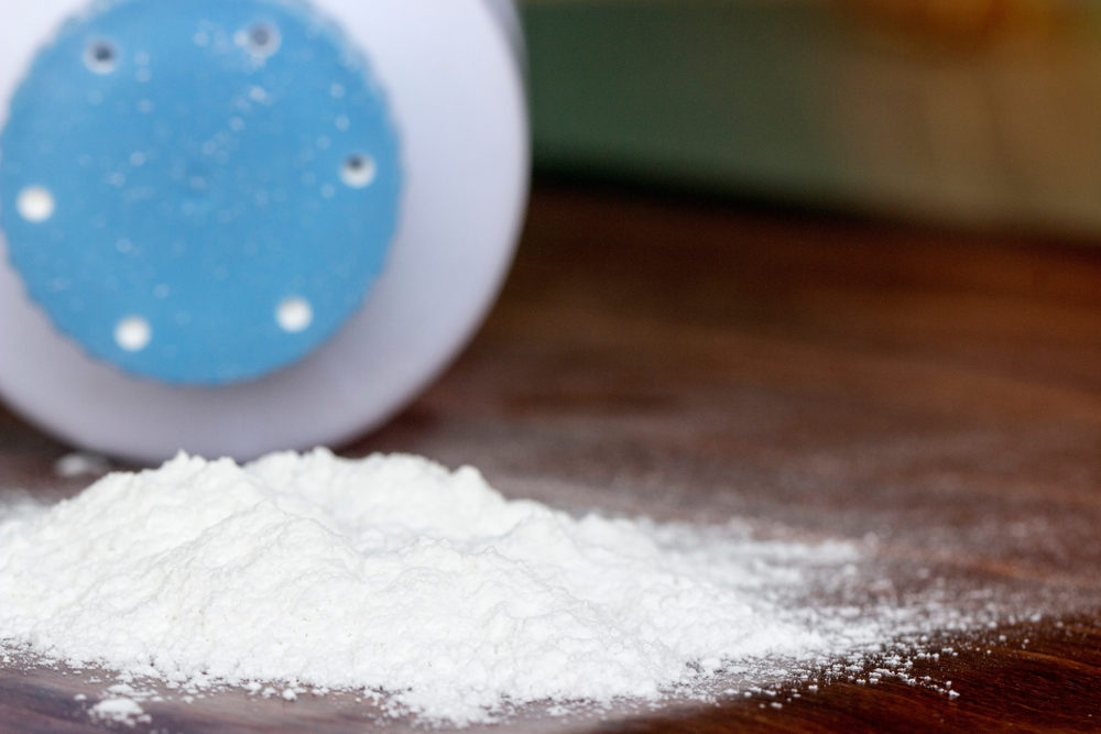 Baby talcum powder container on wooden background