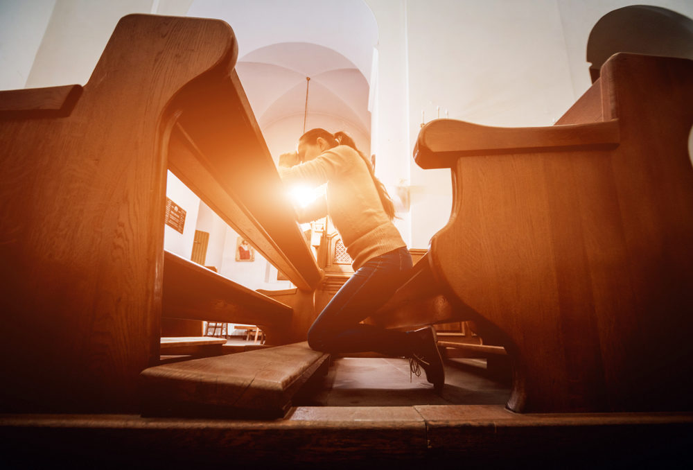 Christian woman praying in church.