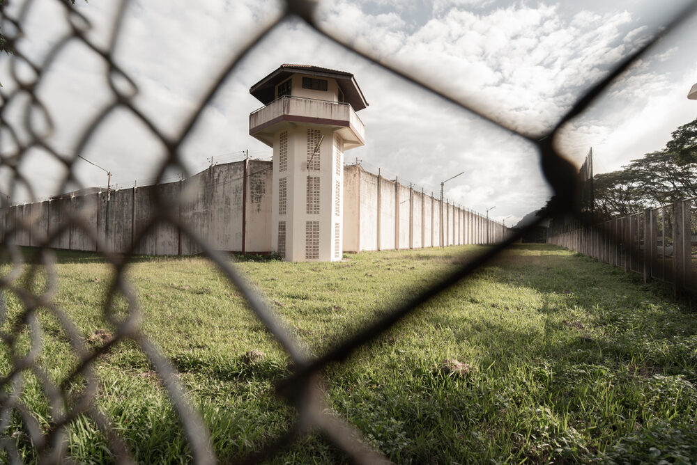 Alfonzia Newsome, Former SCI at Cambridge Springs Corrections Officer Ordered to Stand Trial for Sexual Assaulting Two Female Inmates a view of a prison through a chain link fence