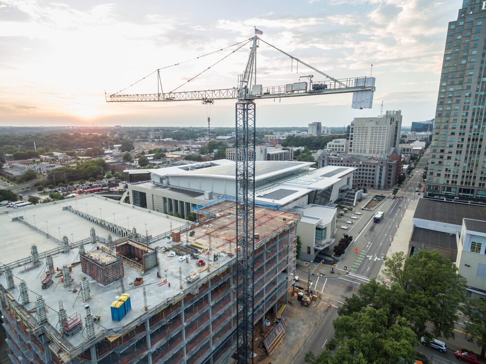 North Carolina Workplace Injury Rate Lower Than National Average sunset behind a downtown raleigh,nc construction site crane