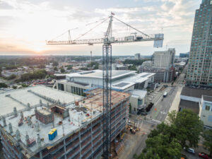 sunset behind a downtown raleigh,nc construction site crane