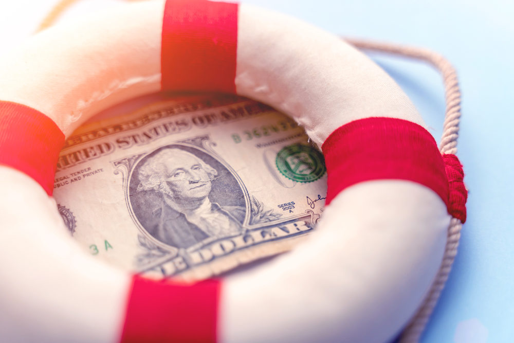 Lifebuoy on US dollar with blue background financial rescue concept