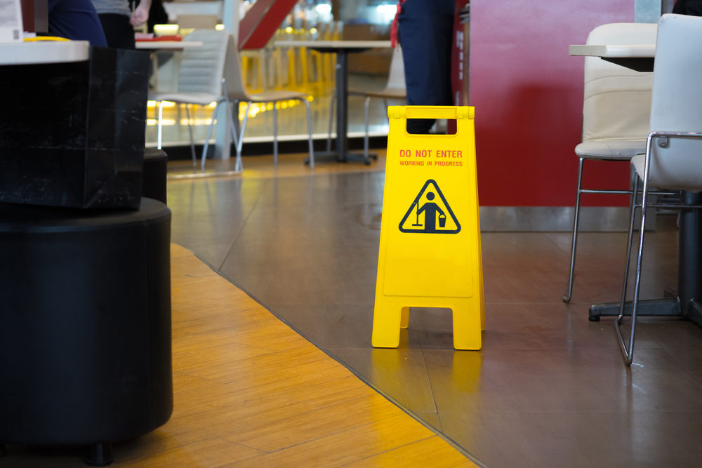 How to Build a Strong Personal Injury Claim Against a Restaurant Yellow sign that alerts for wet floor in the restaurant