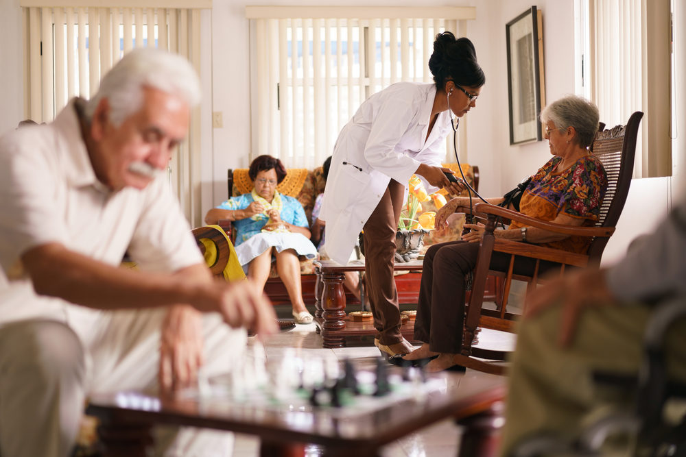 black female doctor testing a resident in a retirement home for seniors