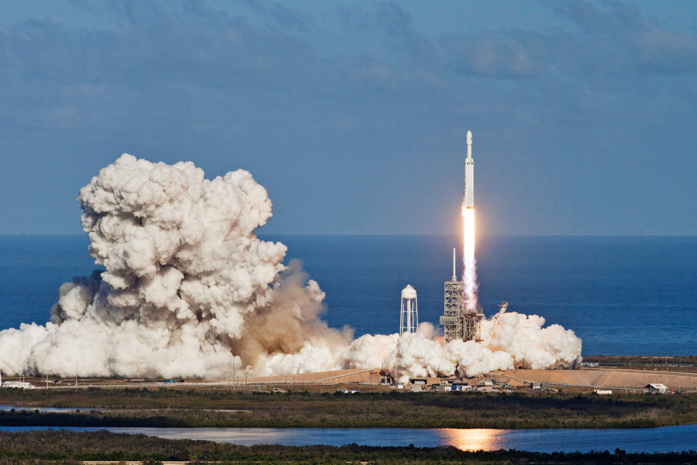 A large rocket ascends from the launch tower in Florida, with smoke billowing