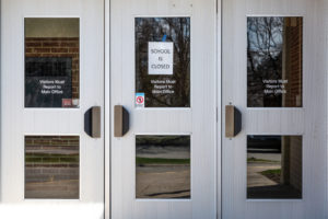 A "school closed" notice at the entrance of a public school in Michigan.