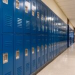Empty school hallway with blue metal student lockers