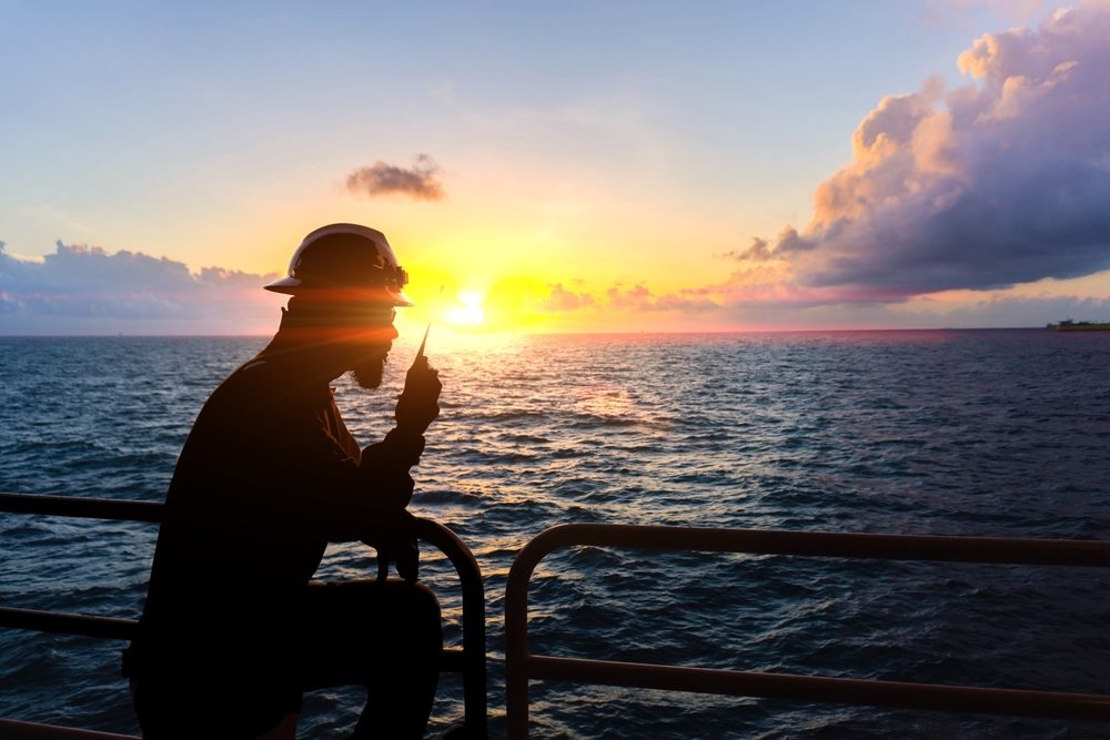 Offshore crew holding walkie talkie