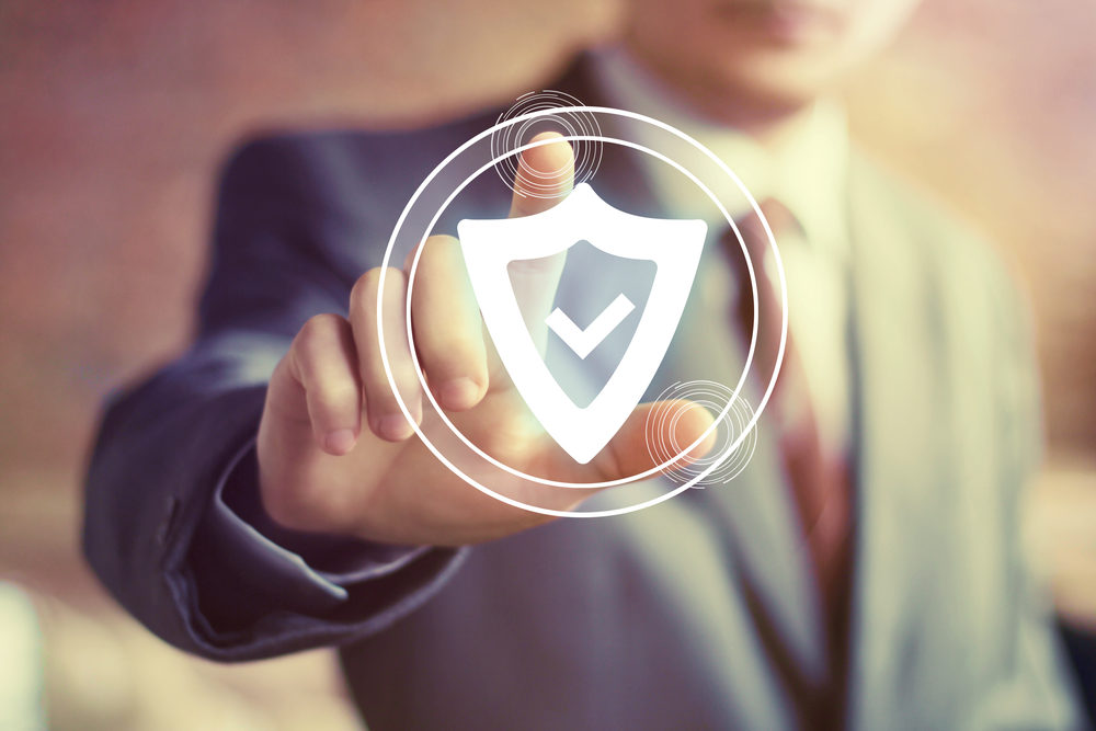 How to Improve Communication Security for Your Clients A man presses on a glowing Shield icon floating in the air