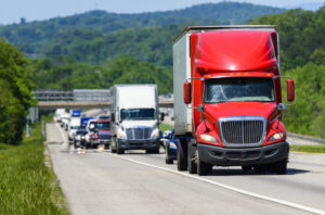 A red semi leads a line of traffic down an interstate highway in Tennessee. 