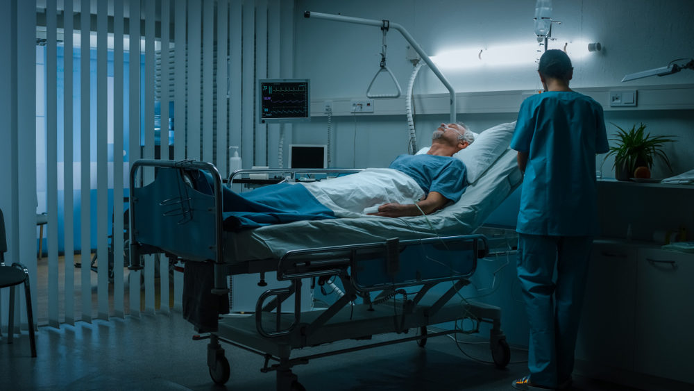 In the Hospital Senior Patient Rests on the Bed, Nurse in Ward Does Checkup