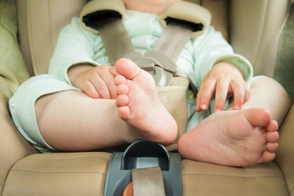 Close-up of a baby strapped into a carseat