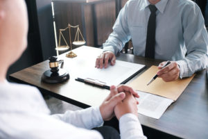 Legal counsel presenting a contract to a client