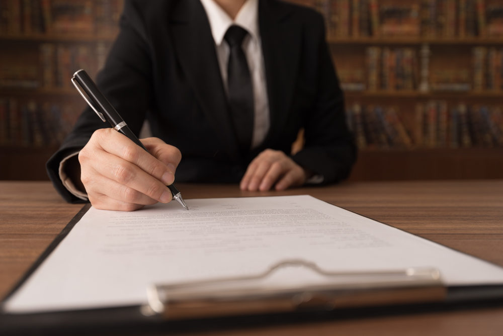 An attorney signing a legal document