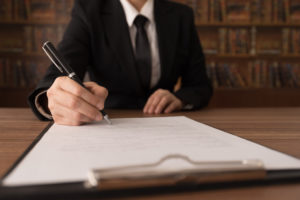 An attorney signing a legal document
