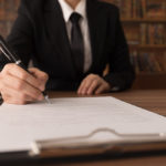 An attorney signing a legal document